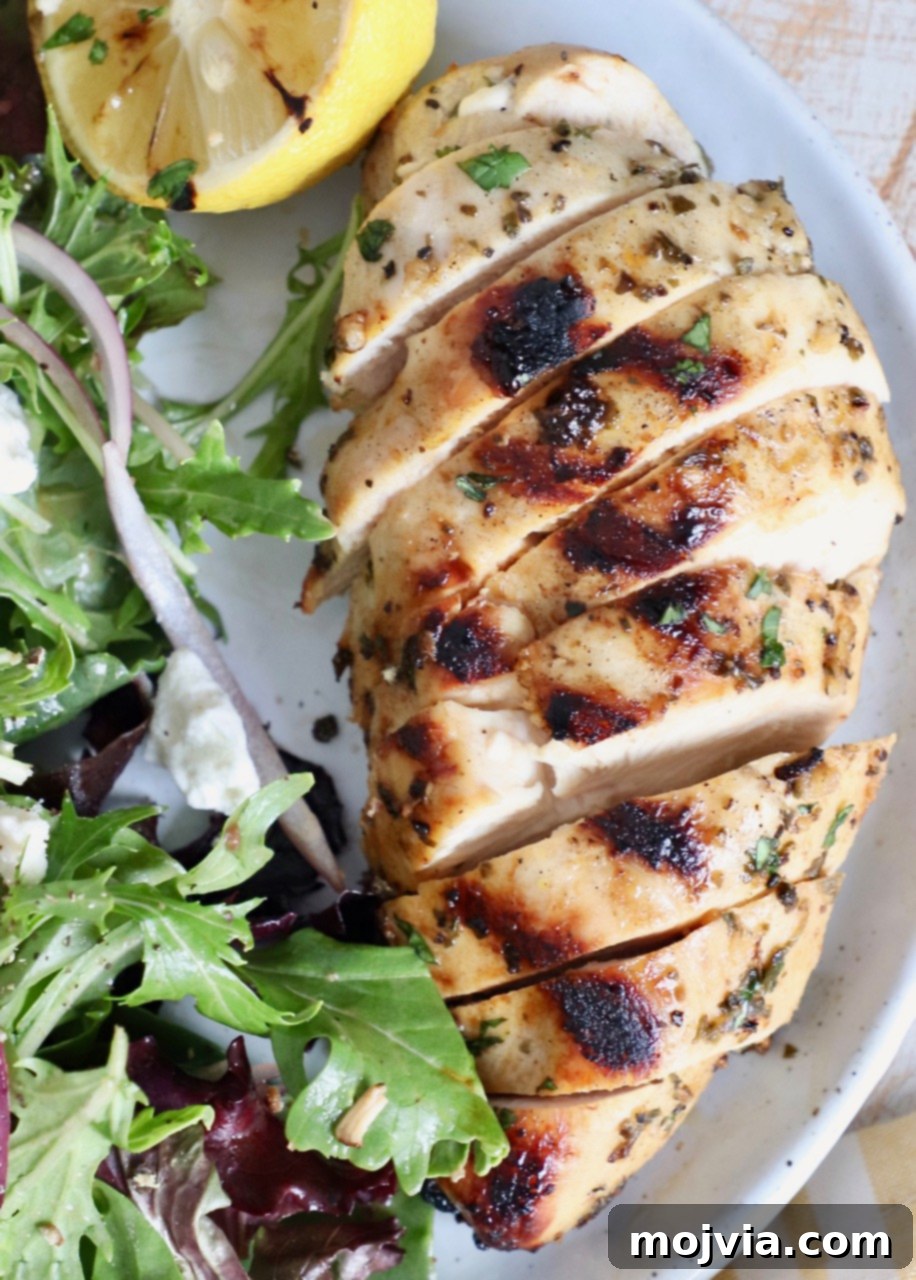 Greek Lemon Herb Chicken Marinade 6 grilled sliced chicken on plate with salad
