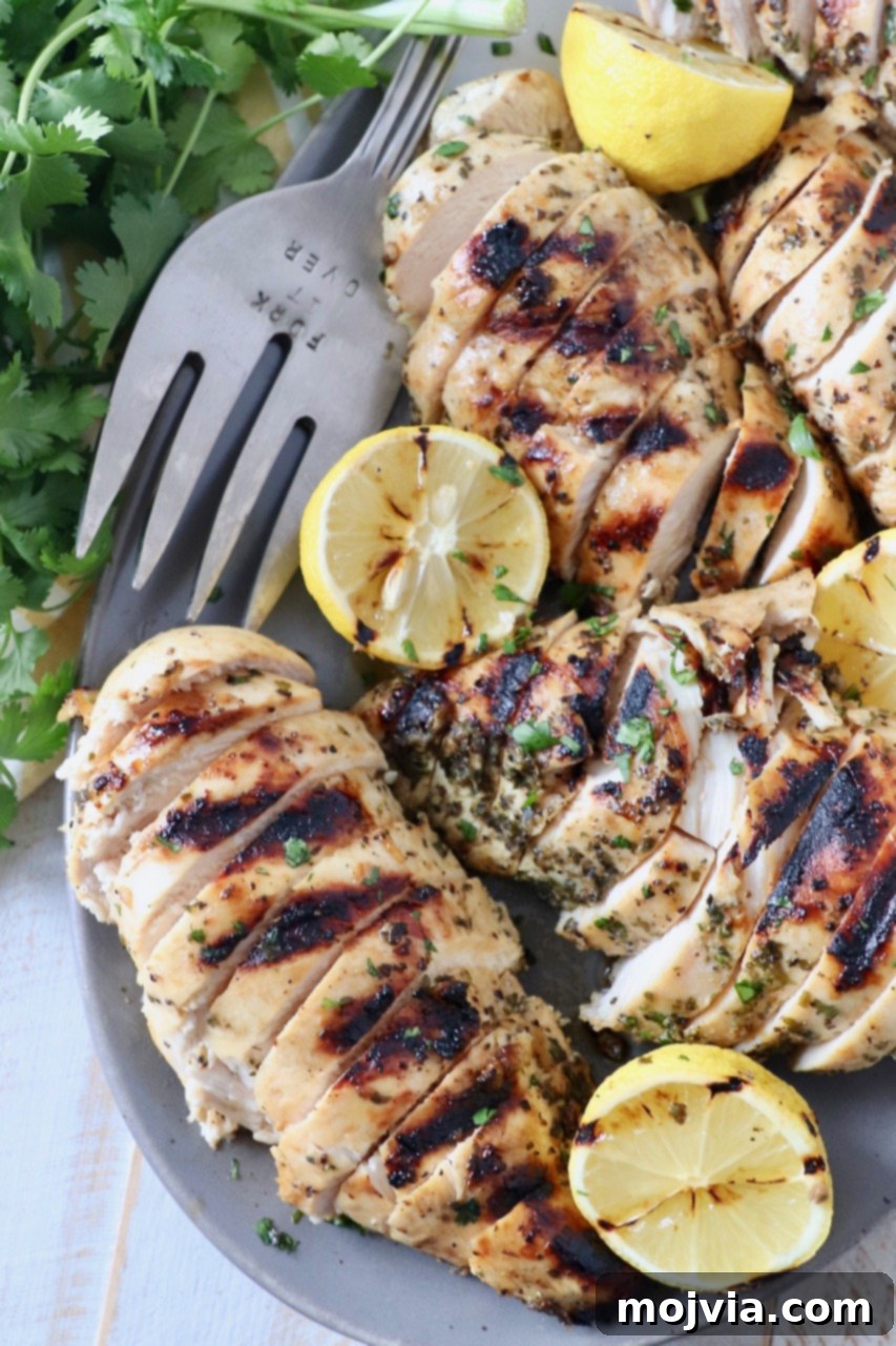 Greek Lemon Herb Chicken Marinade 7 grilled chicken on plate with grilled lemons