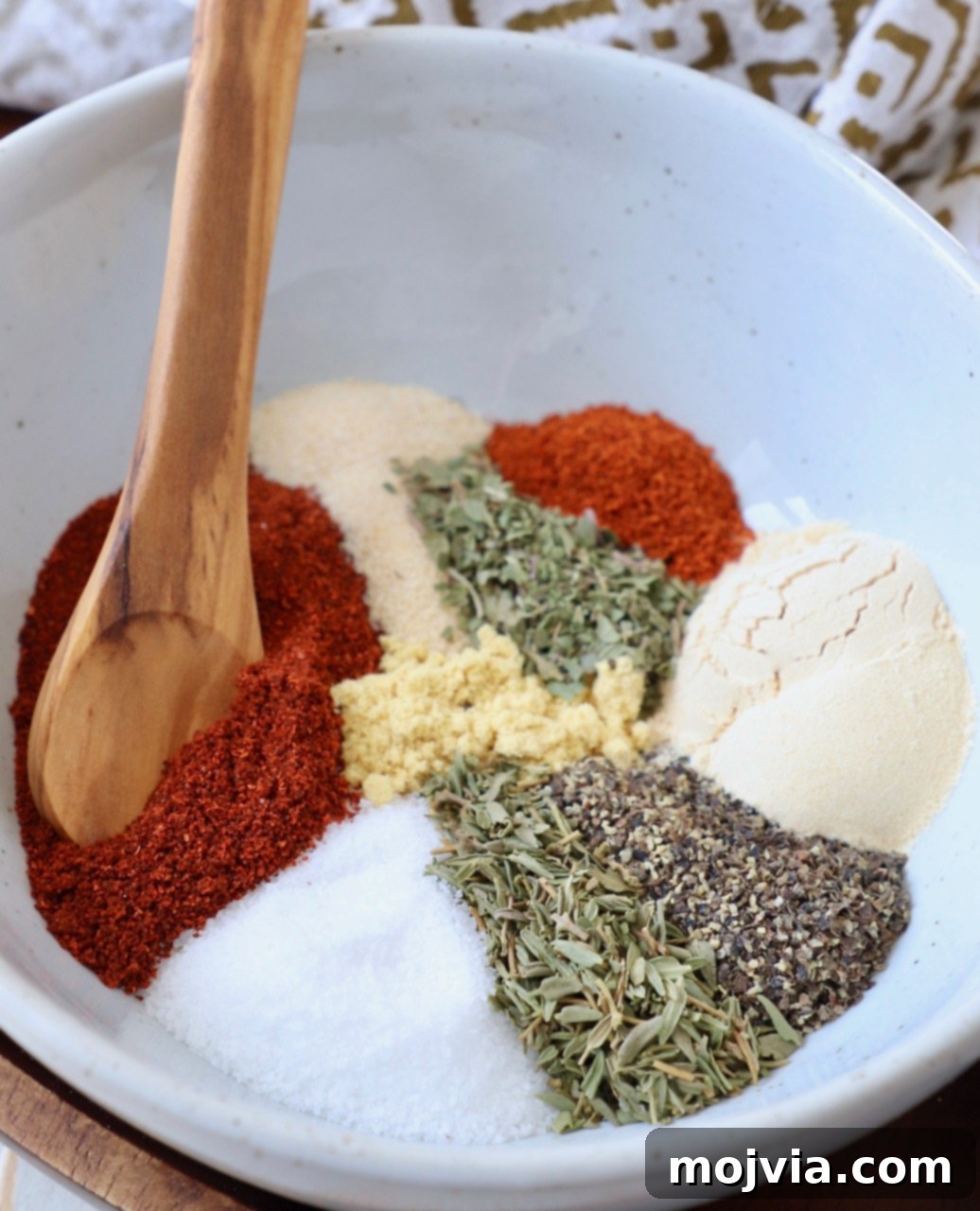 Ultimate Pork Chop Rub 7 A beautiful array of individual spices and herbs in a bowl, illustrating the simplicity and quality of homemade pork chop seasoning ingredients.