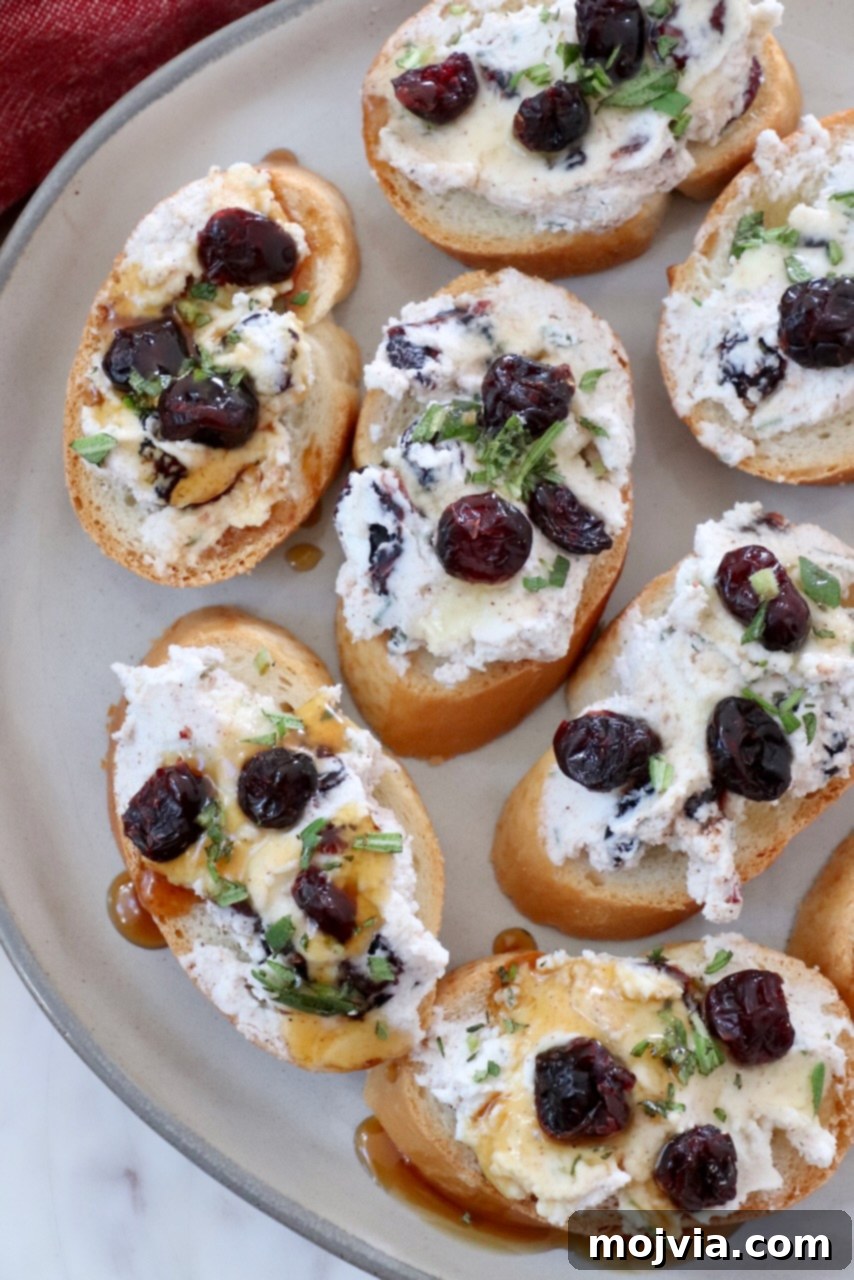 Creamy Goat Cheese and Tart Cranberry Crostini 6 cranberry goat cheese crostini on a plate