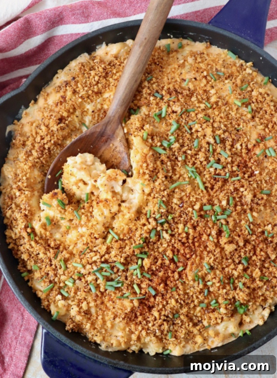 Velvet Smoke Mac 19 mac and cheese in large skillet with wooden serving spoon
