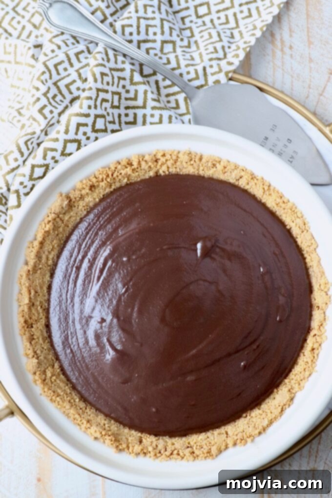The assembled chocolate pie, nestled in its graham cracker crust, chilling in the refrigerator.