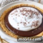 chocolate pie topped with whipped cream in pie plate