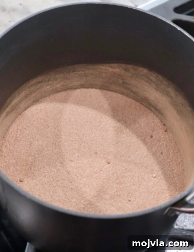 Granulated sugar, all-purpose flour, and unsweetened cocoa powder mixed together in a saucepan for the chocolate pie filling.