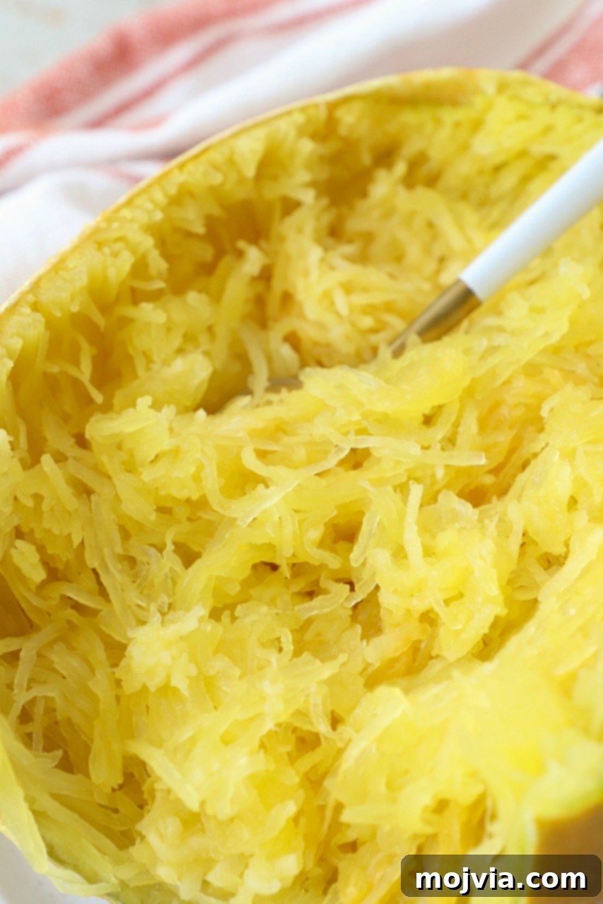 cooked spaghetti squash on plate with fork