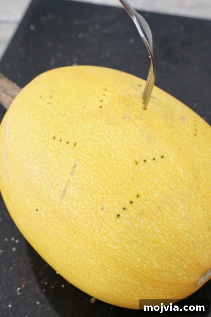 fork stuck in spaghetti squash to poke holes