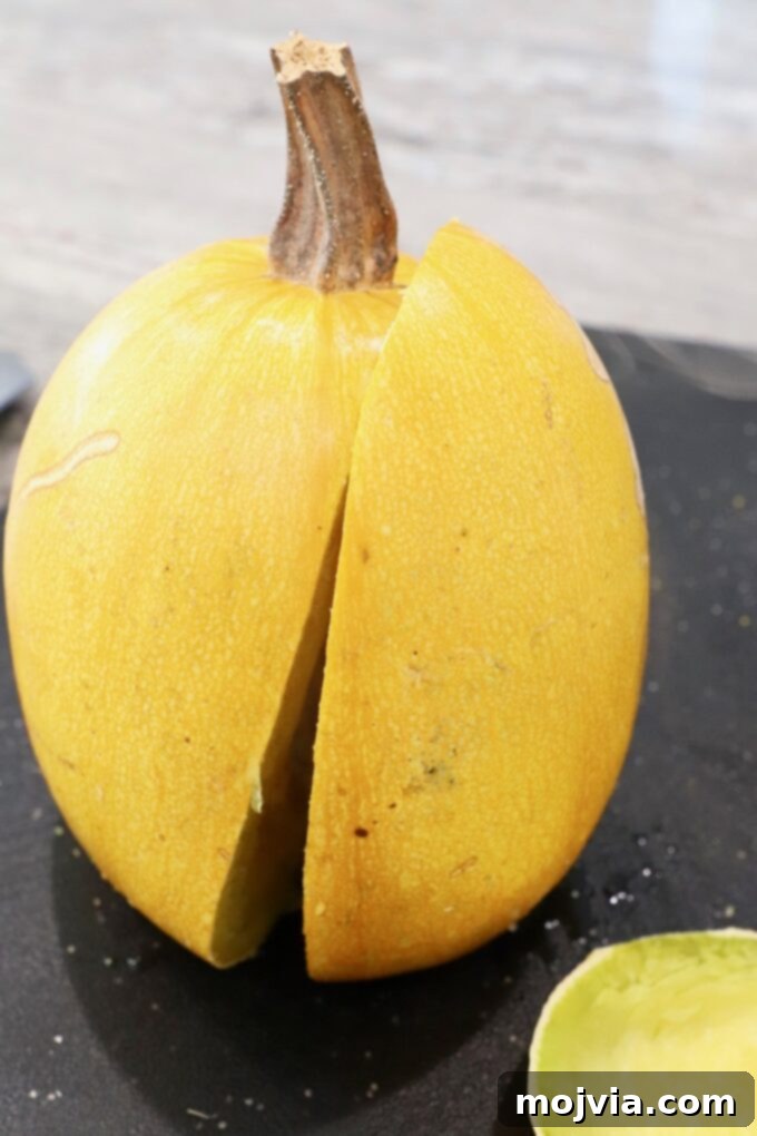 spaghetti squash standing up on cutting board cut in half