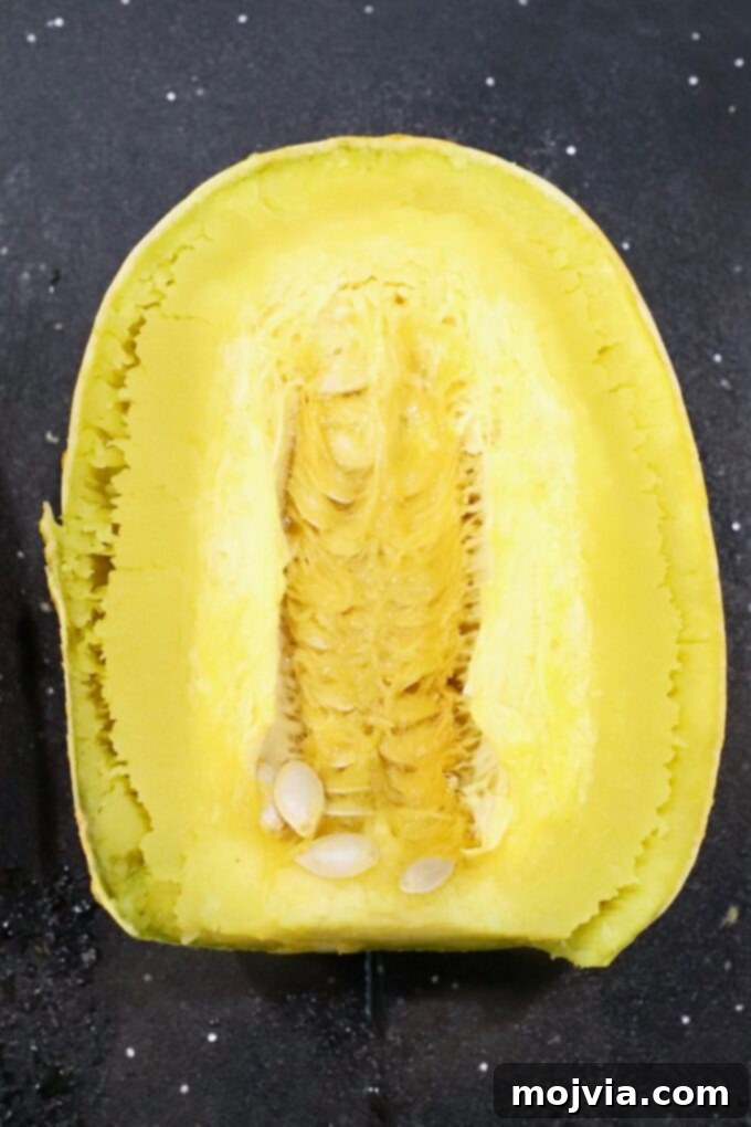 microwaved spaghetti squash cut in half on cutting board