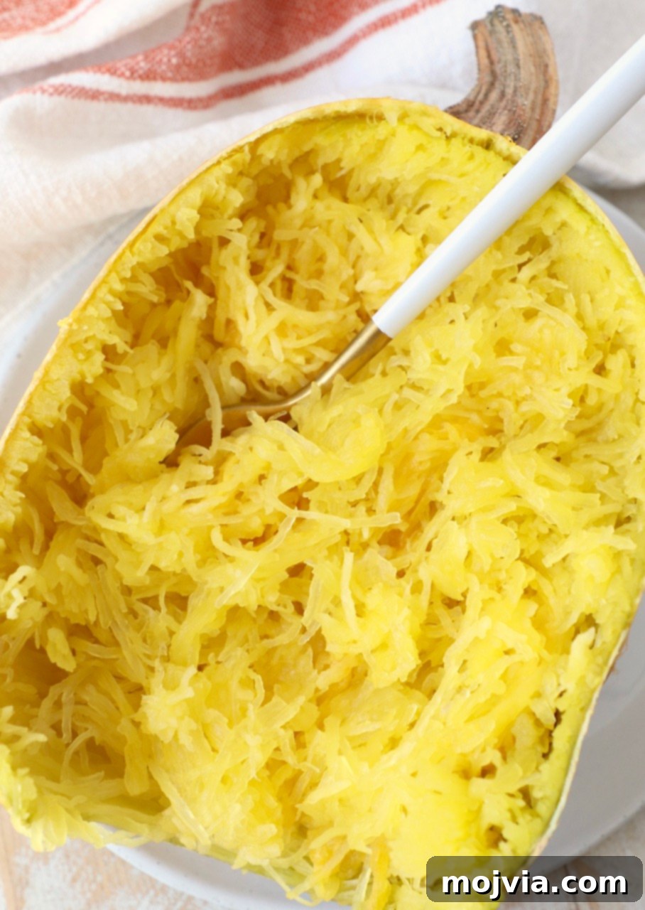 microwaved spaghetti squash half on plate with fork