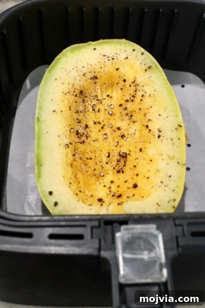 uncooked spaghetti squash half in air fryer
