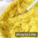 cooked spaghetti squash on plate with fork