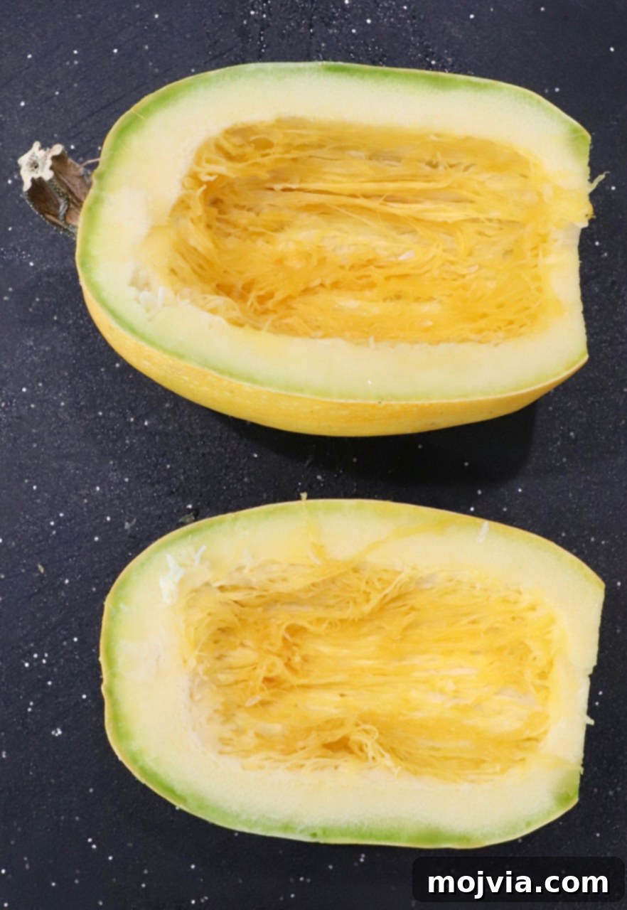 spaghetti squash cut in half on cutting board