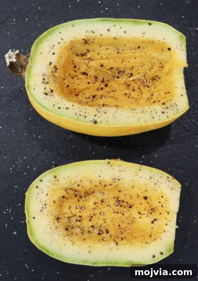 seasoned spaghetti squash halves on cutting board