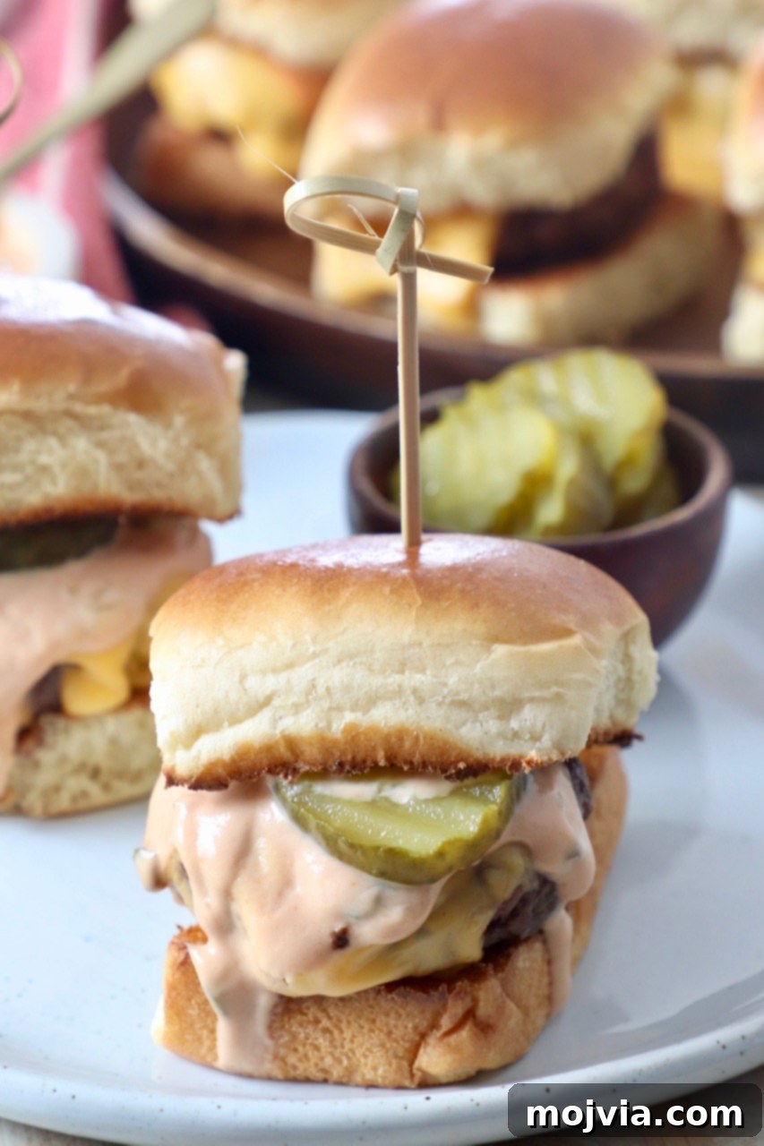 cheeseburger sliders on plate with pickles