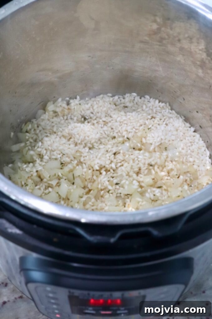 Quick & Creamy Instant Pot Risotto 5 arborio rice in Instant Pot with cooked onions