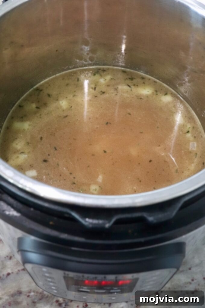 Quick & Creamy Instant Pot Risotto 7 chicken broth in Instant Pot with rice and onions