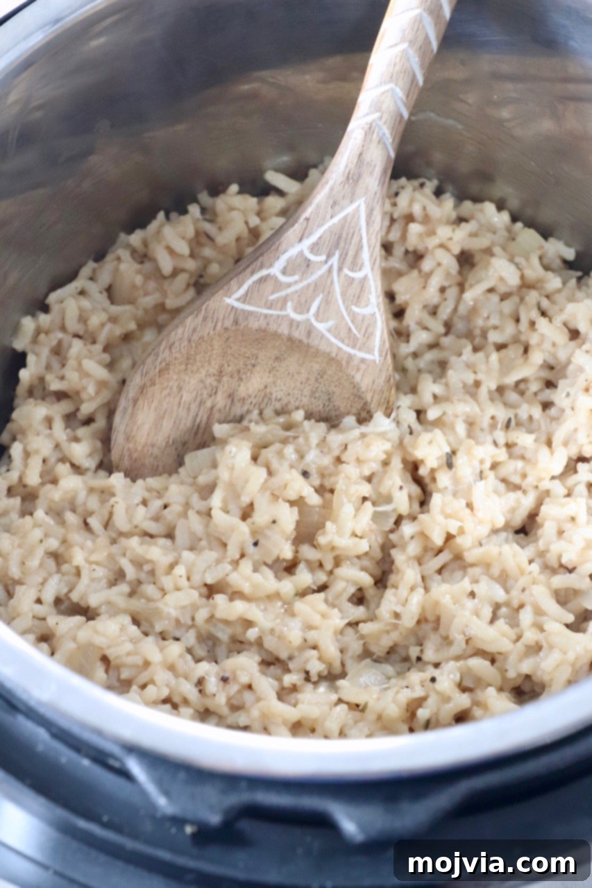 Quick & Creamy Instant Pot Risotto 10 cooked risotto in Instant Pot with serving spoon