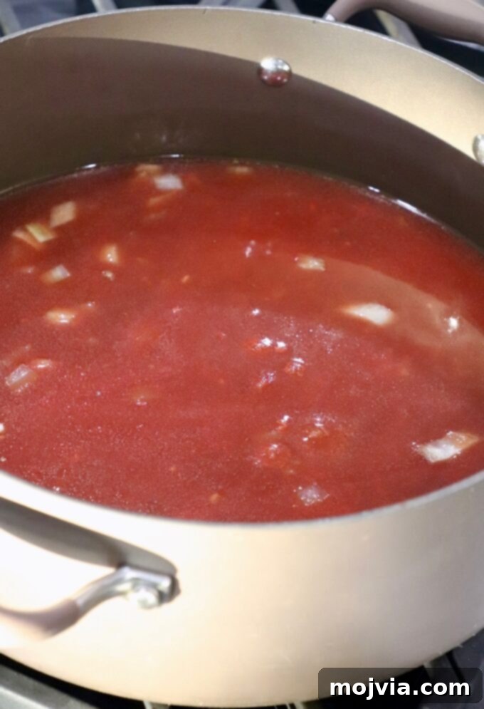 Ultimate Comfort Meatball Soup 4 tomato sauce in large pot on the stove
