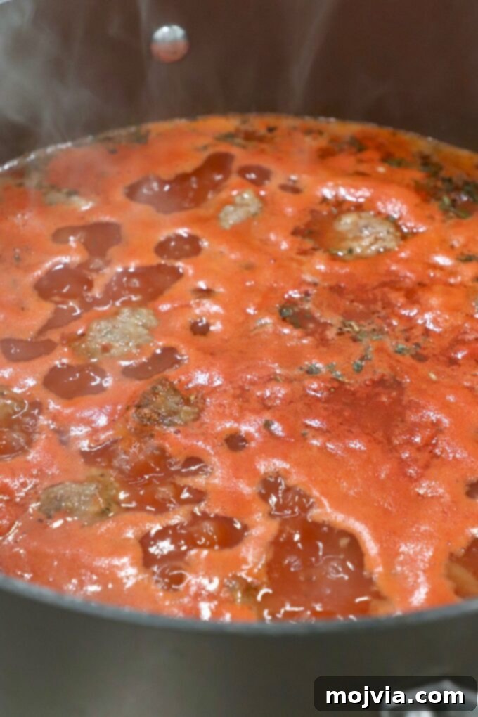 Ultimate Comfort Meatball Soup 6 soup simmering in pot