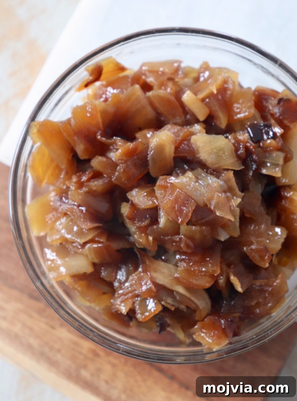 Crafting Irresistible Caramelized Onions 2 A small glass bowl filled with perfectly diced, golden-brown caramelized onions, ready to enhance any dish.