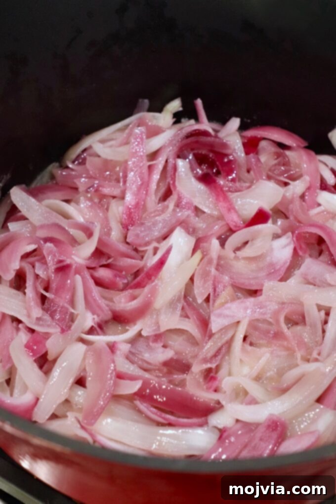 Crafting Irresistible Caramelized Onions 10 Sliced onions beginning to soften and turn translucent in the skillet after a few minutes of cooking.