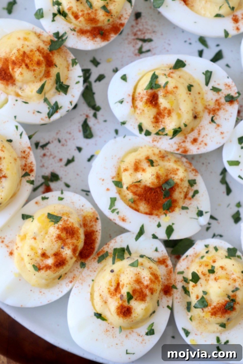 Family Favorite Deviled Eggs 8 overhead image of deviled eggs on plate topped with fresh chopped parsley
