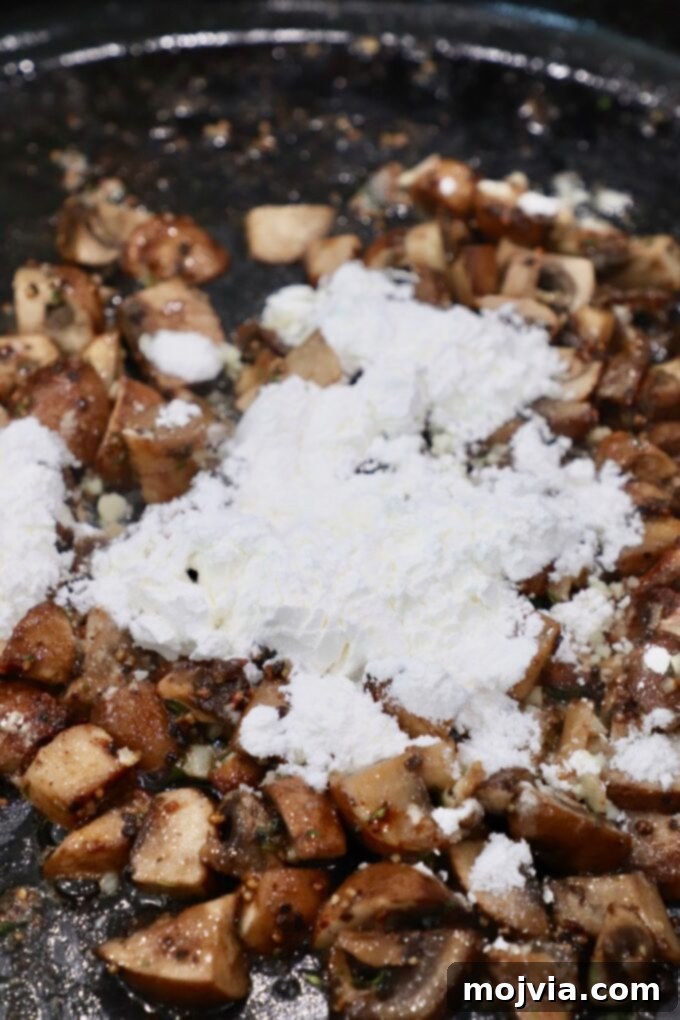 Velvety Mushroom Delight 5 Cornstarch being sprinkled over sautéed mushrooms in a skillet with garlic.