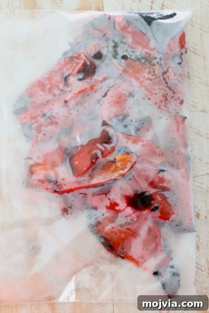 Fire Kissed Red Peppers 7 roasted red peppers steaming in zipper plastic bag for easy peeling