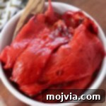 Fire Kissed Red Peppers 10 Close-up of roasted red peppers in a white bowl