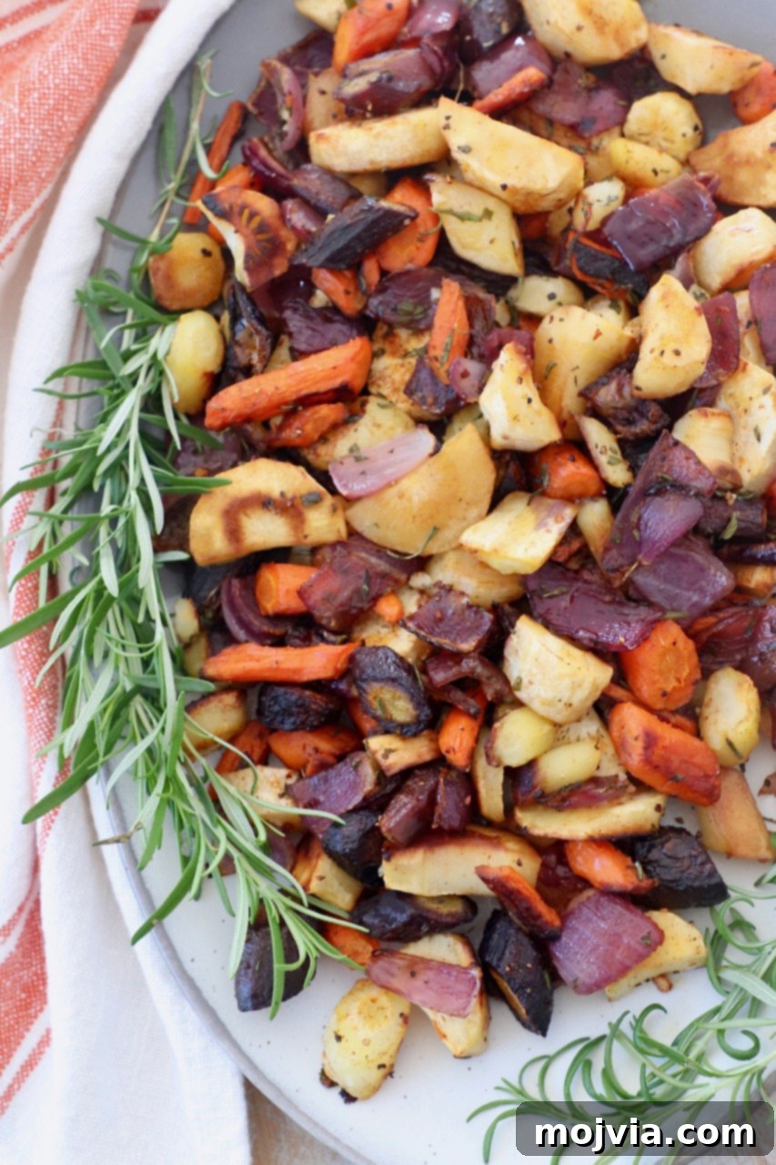 Earthy Harvest Roast 6 Beautifully roasted root vegetables, garnished with fresh rosemary sprigs, served on a white plate.