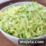 Shredding Brussels Sprouts Made Simple 13 shredded brussels sprouts in white bowl
