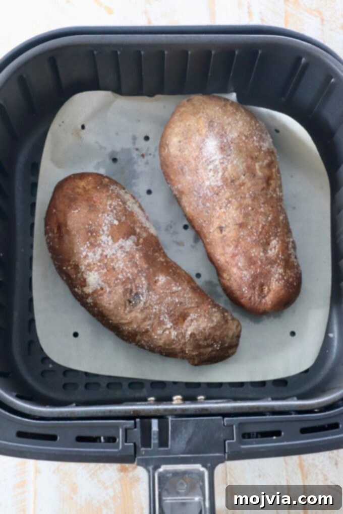 Crispy Air Fryer Baked Potatoes 4 cooked russet potatoes in air fryer basket