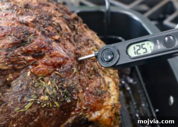 thermometer that reads 125 degrees stuck in cooked prime rib