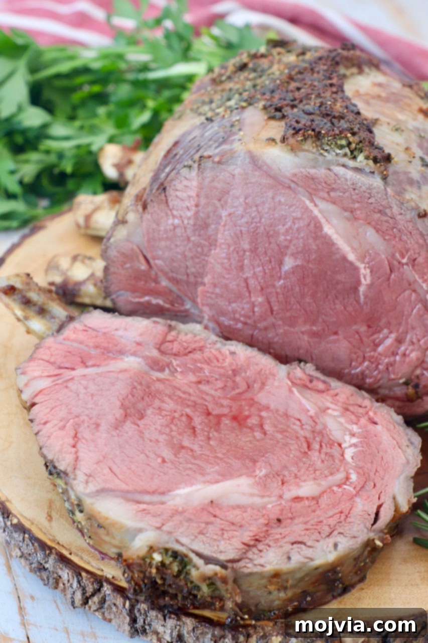 bone in prime rib on wood cutting board with slice cut off of the meat