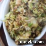 cooked shaved brussels sprouts in white serving dish