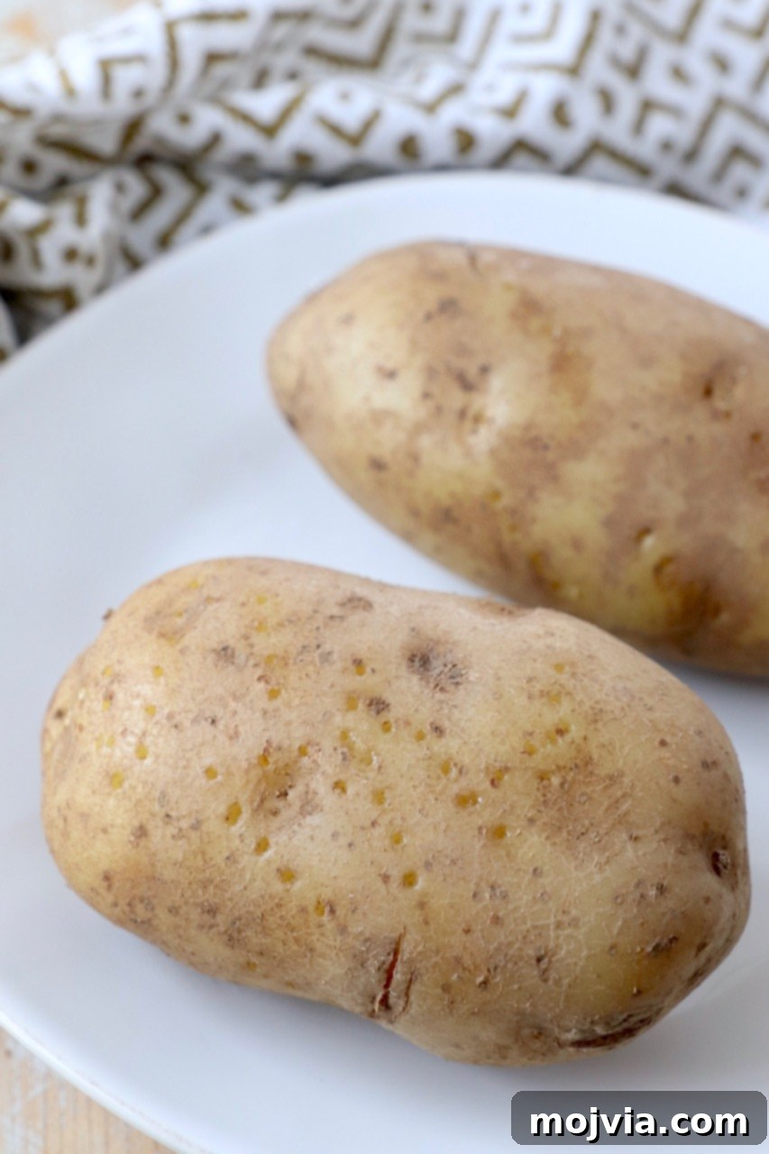 Perfect Instant Pot Baked Potatoes 6 Cooked russet potatoes served on a white plate
