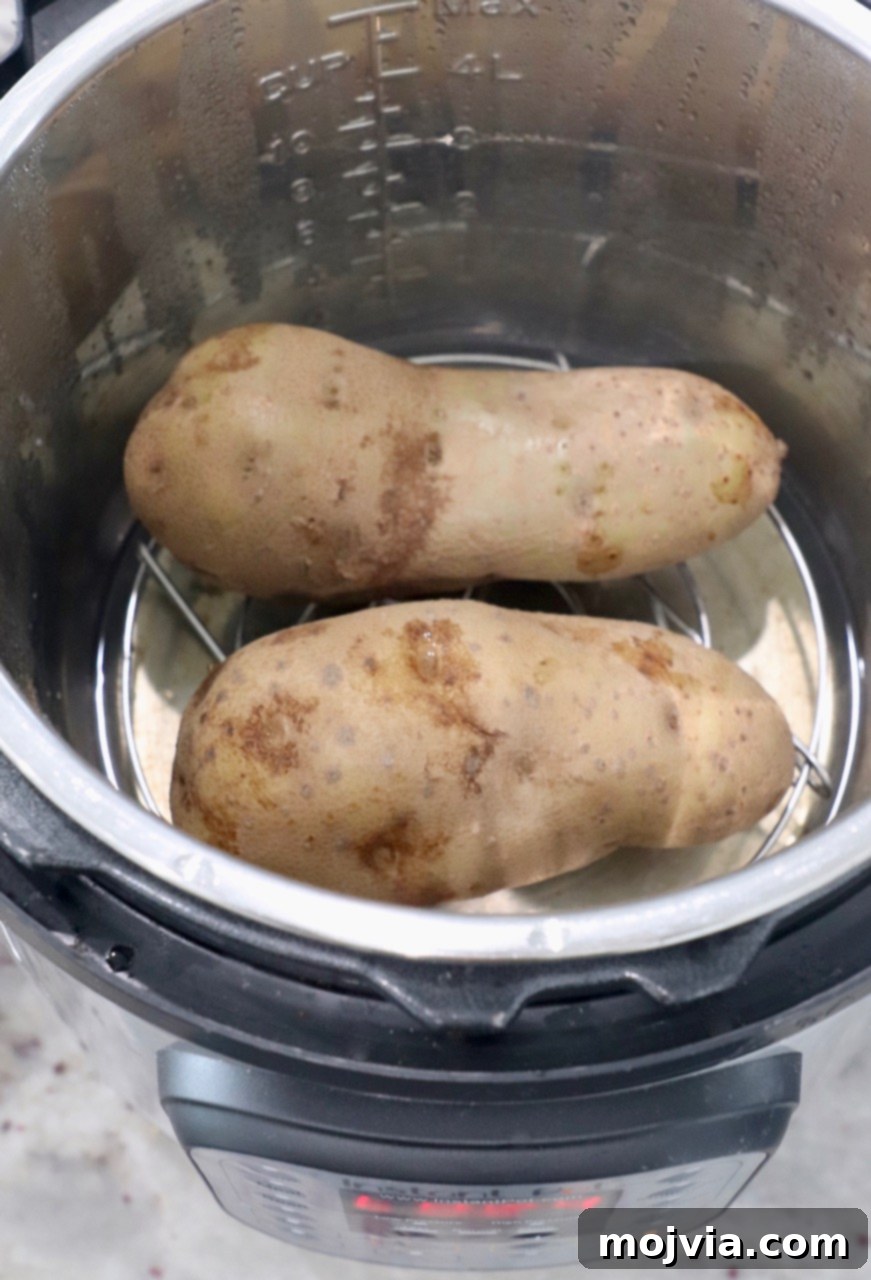 Perfect Instant Pot Baked Potatoes 7 Large russet potatoes inside an Instant Pot, ready to be cooked