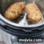Perfect Instant Pot Baked Potatoes 9 Two cooked potatoes in Instant Pot