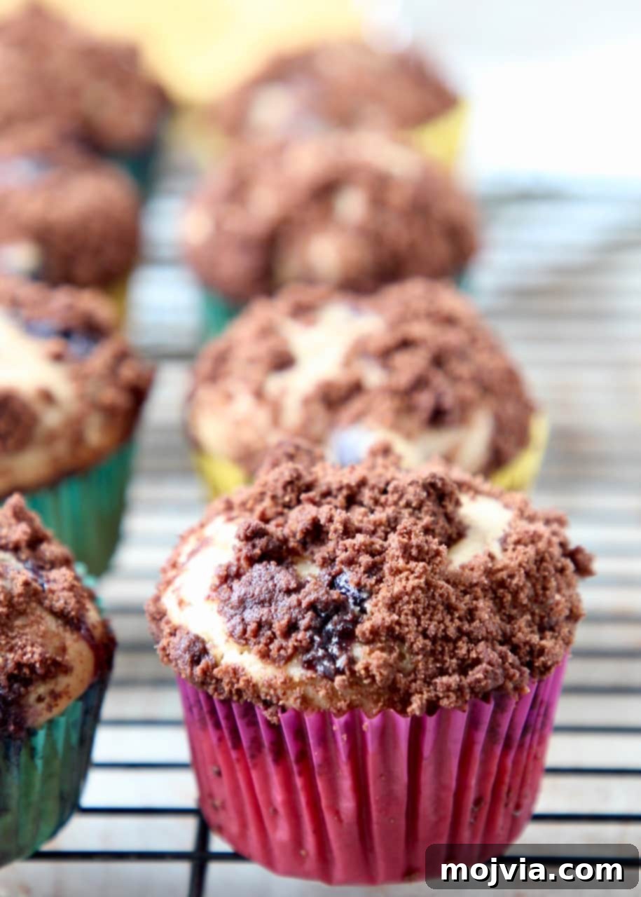 A basket of Blueberry Cream Cheese Muffins with Chocolate Crumble, artfully arranged