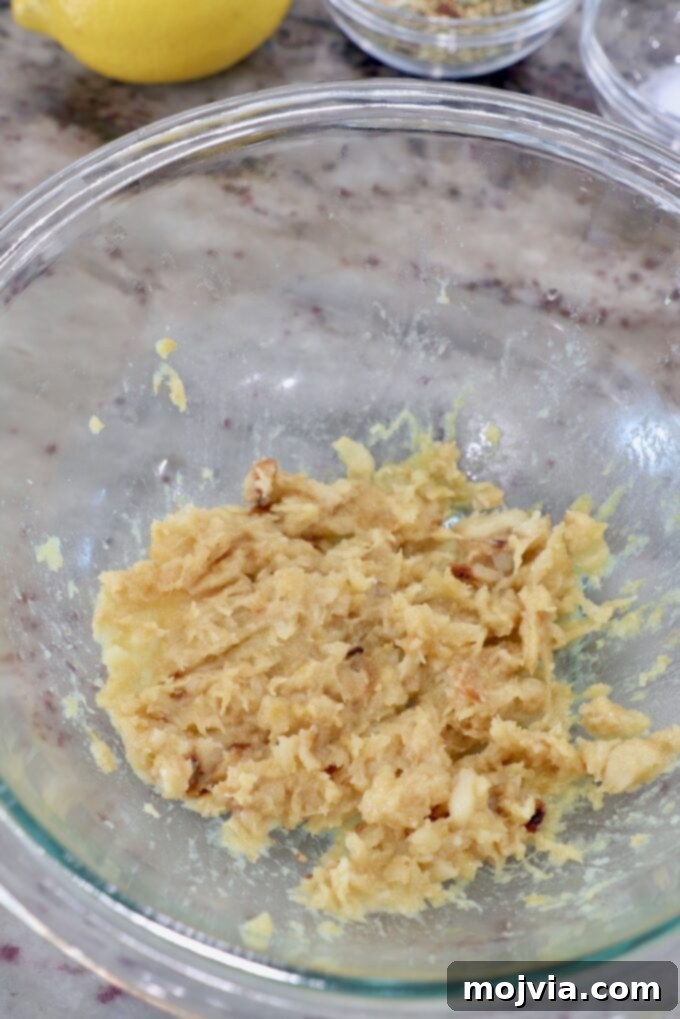 Sweet Roasted Garlic Spread 5 Smashed roasted garlic paste in a glass bowl.
