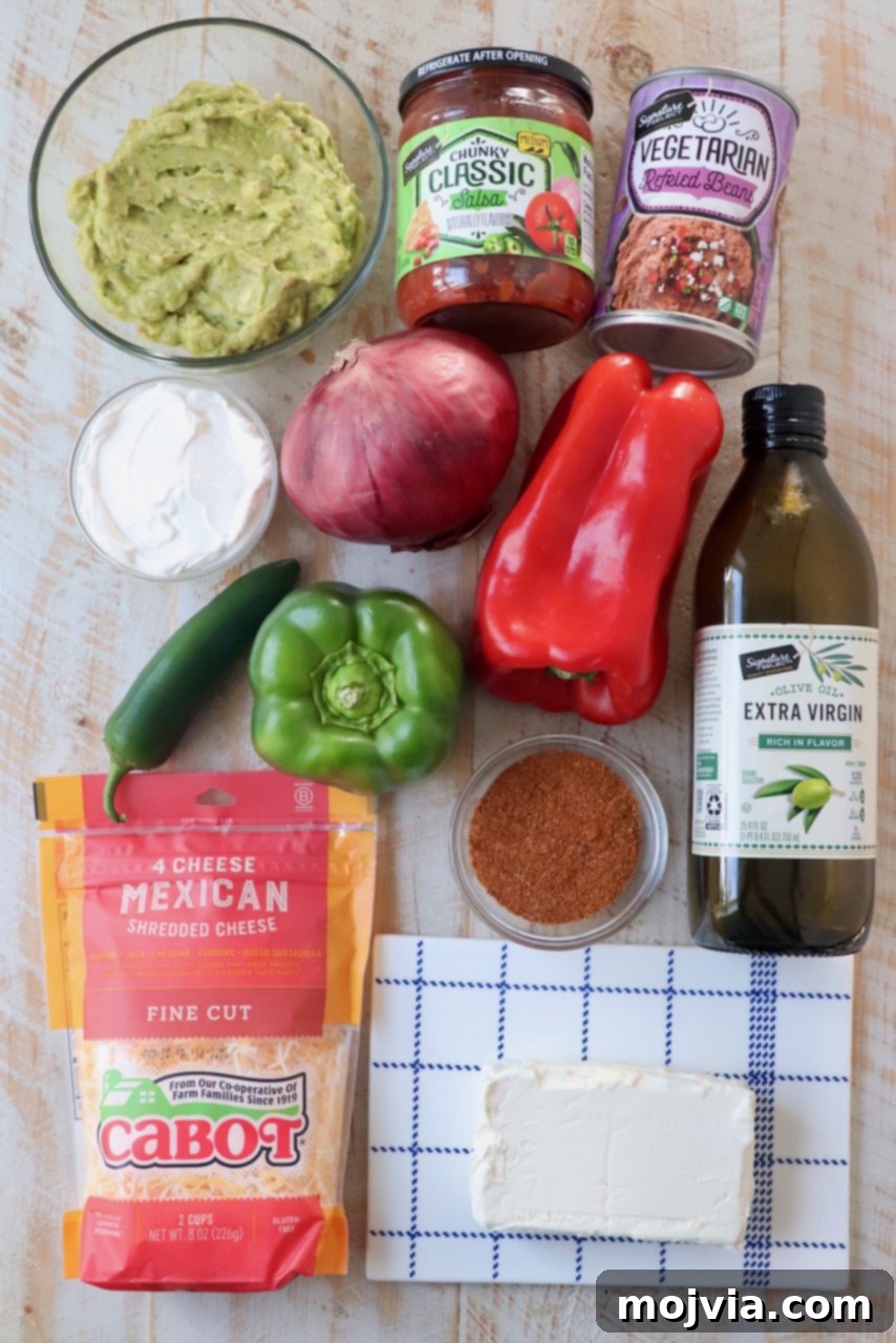 Sizzling Fajita Seven-Layer Dip 3 Fresh ingredients for the seven layer dip neatly arranged on a rustic wooden board
