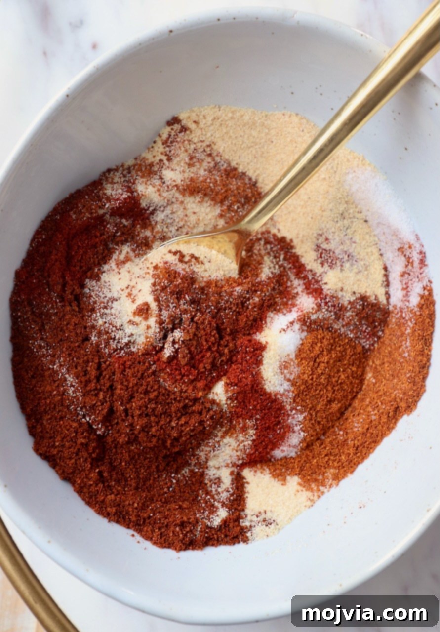 spices mixed together in bowl with gold spoon