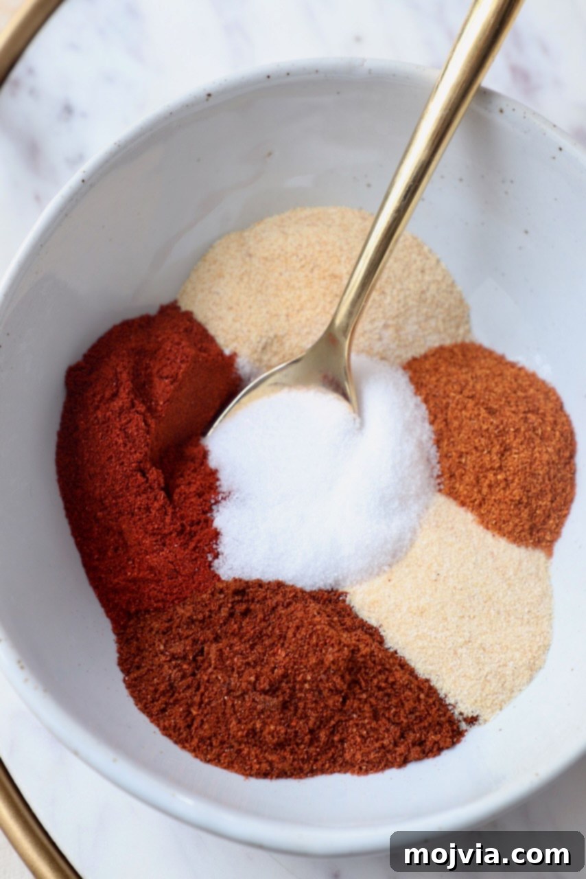spices separated in bowl with gold spoon