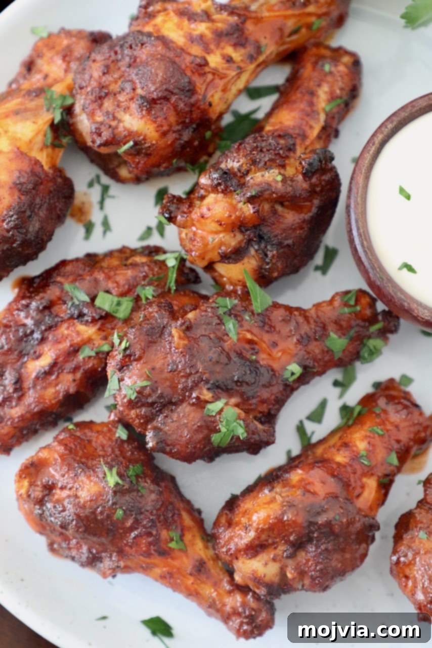 cooked chicken wings tossed in buffalo sauce on plate