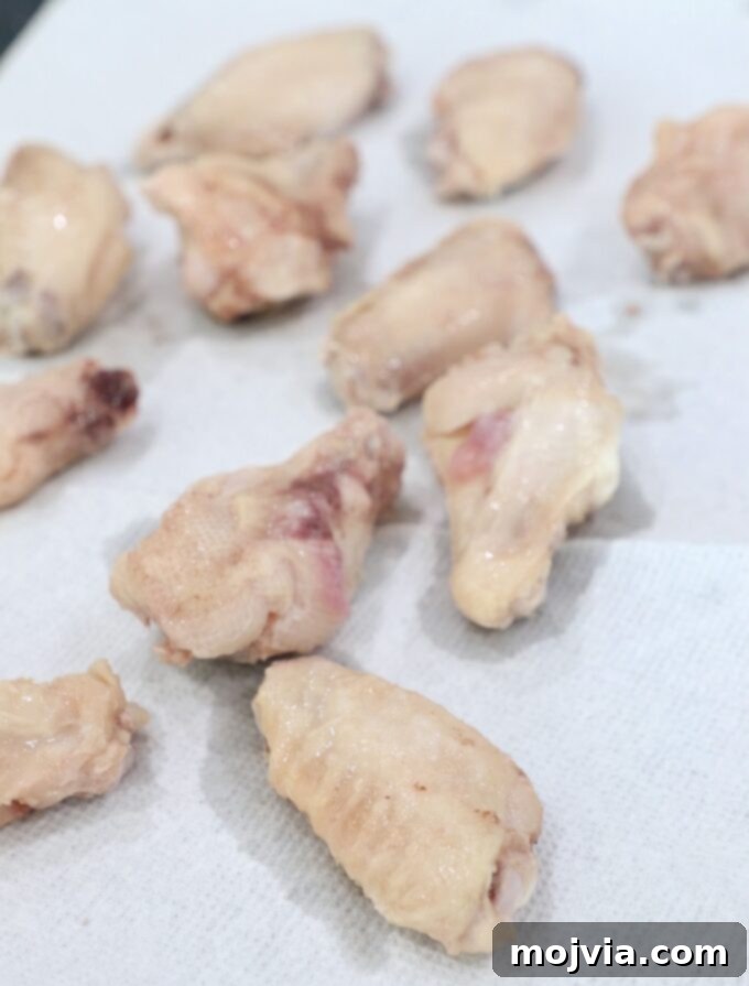 Sous Vide Wings: Crispy, Juicy Perfection 6 cooked chicken wings on paper towels