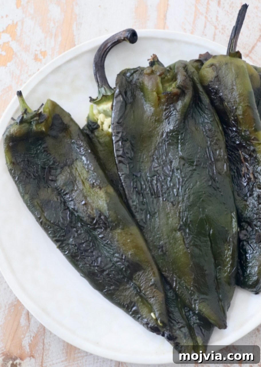Smoky Roasted Poblanos 2 Perfectly roasted poblano peppers ready to be used in various dishes, showcasing their appealing charred skin.