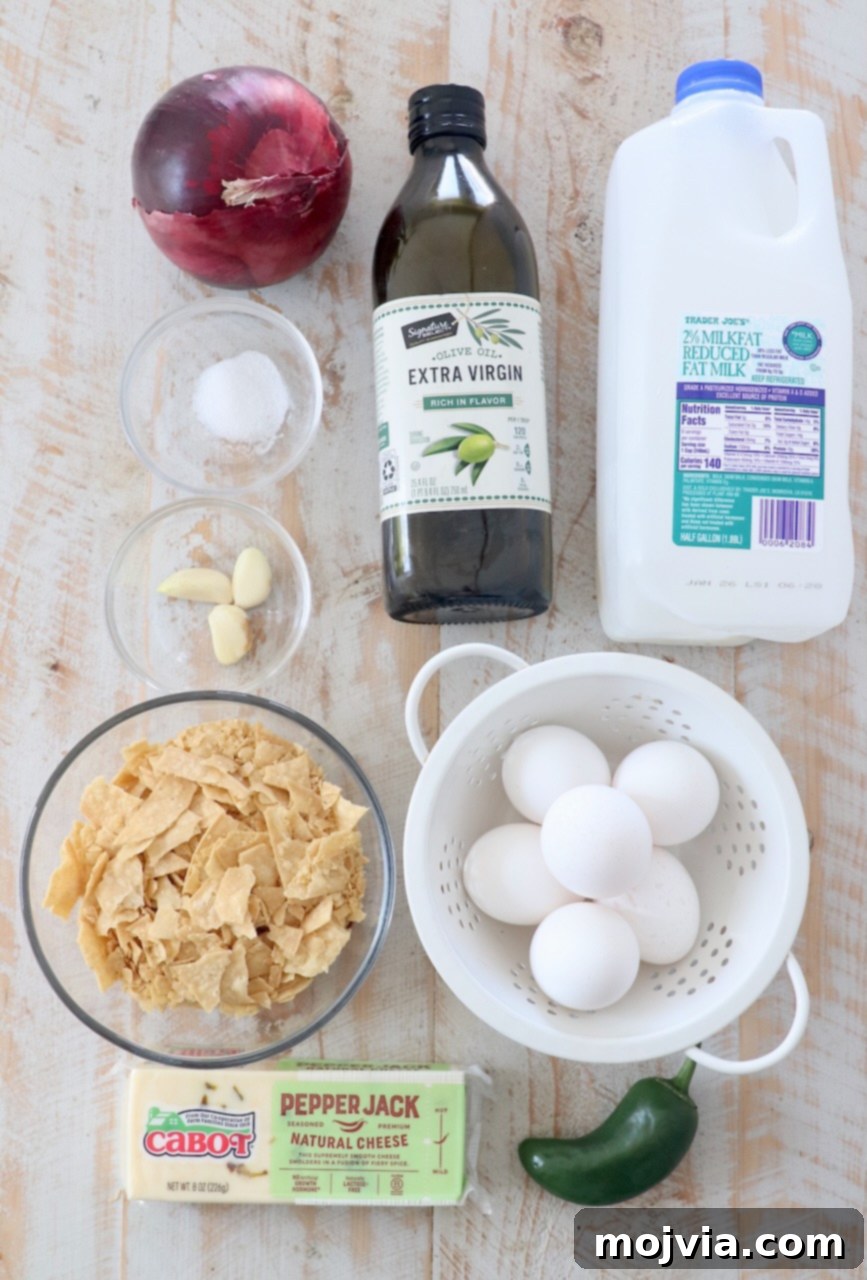 Classic Migas 3 All the fresh ingredients for Tex-Mex Migas neatly arranged on a white wooden cutting board, ready for preparation.