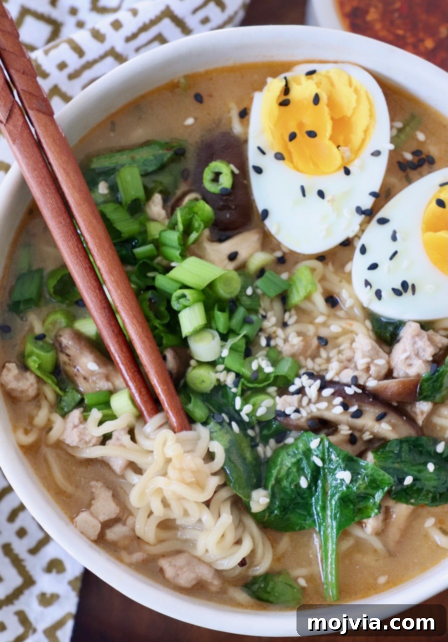 Golden Miso Noodle Perfection 11 A close-up of a steaming bowl of Miso Ramen with a perfectly sliced medium-boiled egg, ready to be enjoyed.