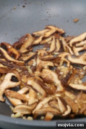 Golden Miso Noodle Perfection 15 cooked shittake mushrooms in wok