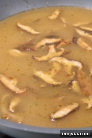 Golden Miso Noodle Perfection 16 sliced mushrooms in broth in wok